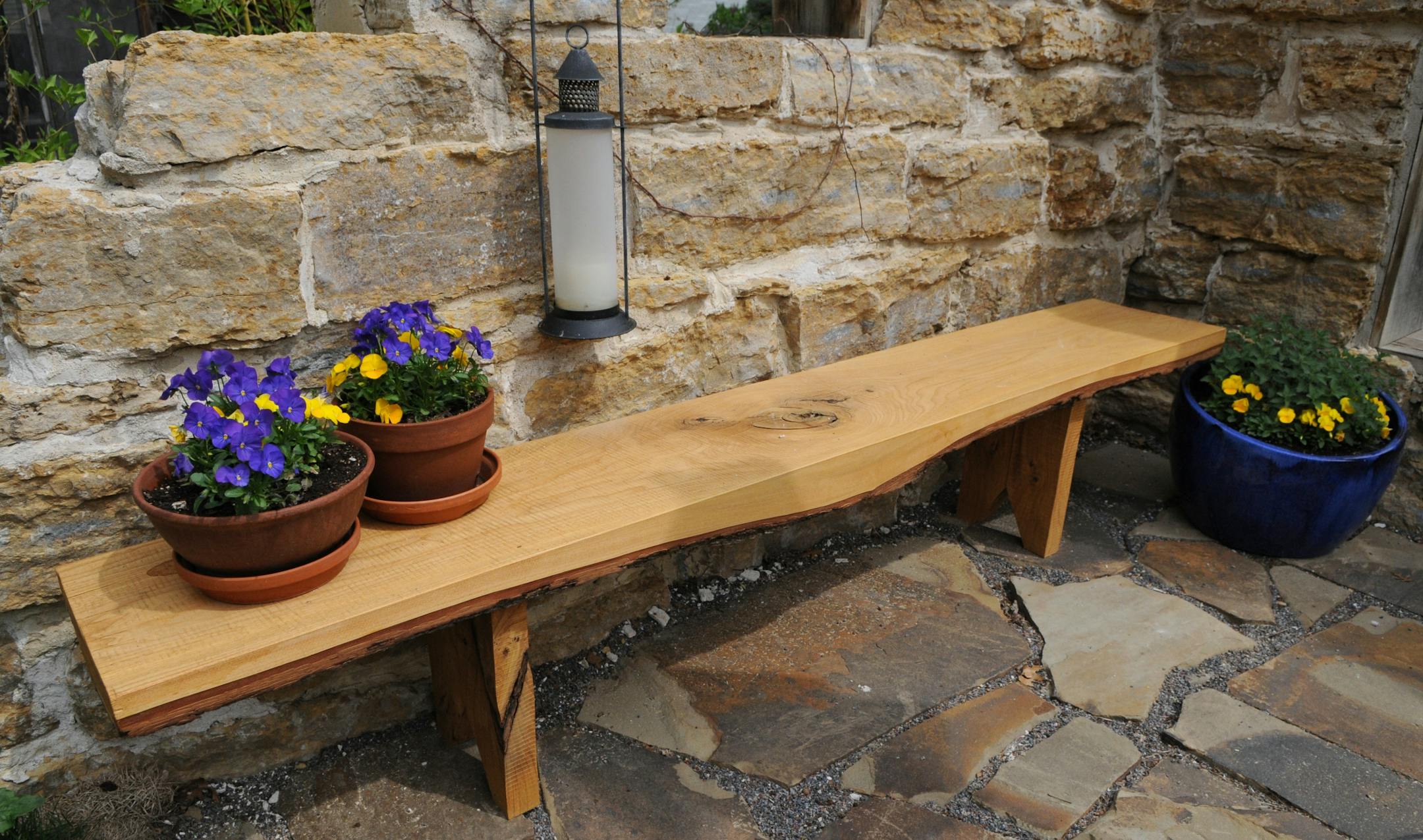 A patio bench made from elm wood.