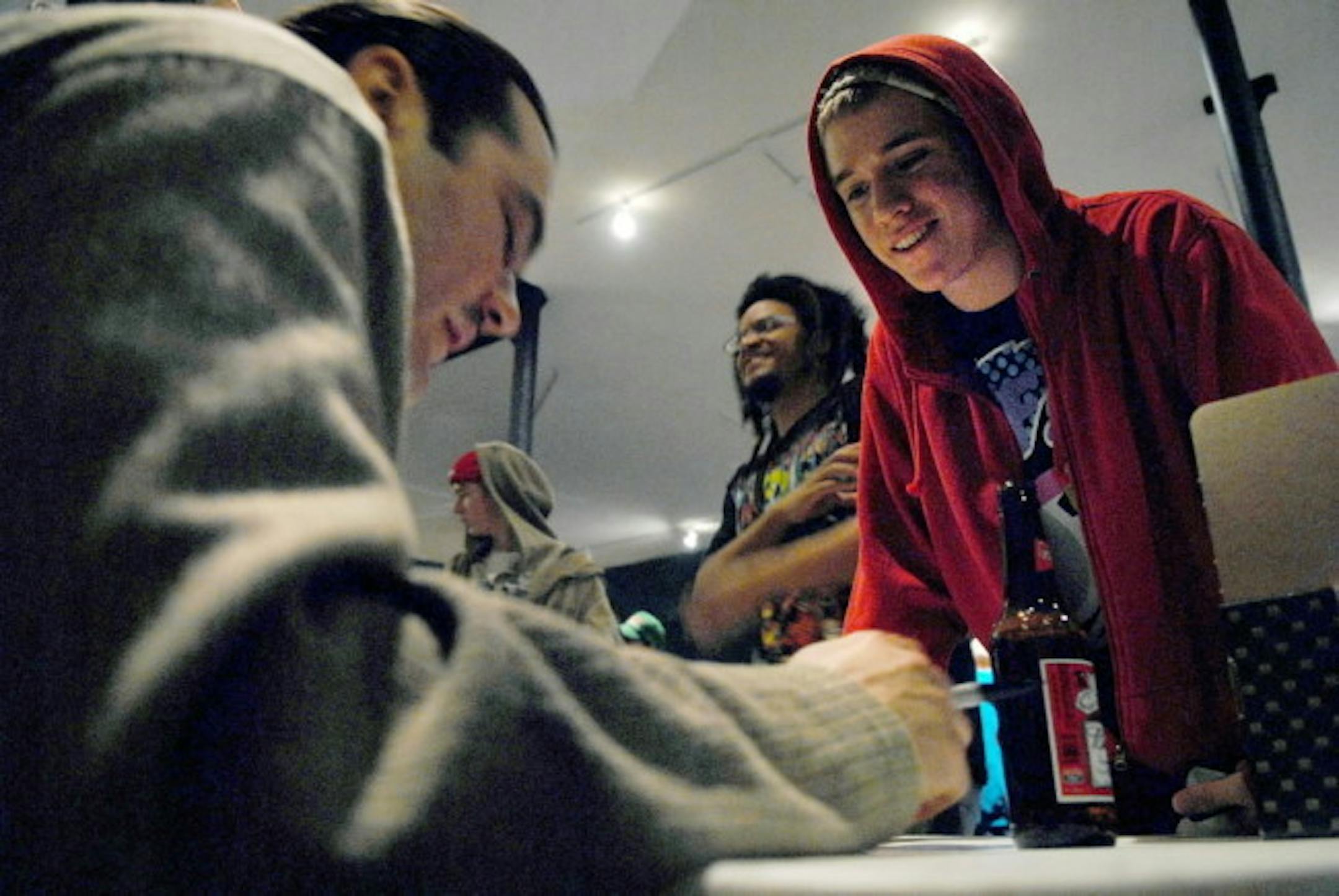 A fan smiles as Atmosphere member Anthony Davis "Ant", left, signs an autograph during the midnight release on Tuesday of Atmosphere's record, "When Life Gives You Lemons, You Paint that Sh*t Gold", at 5th Element Record Store in Minneapolis.
