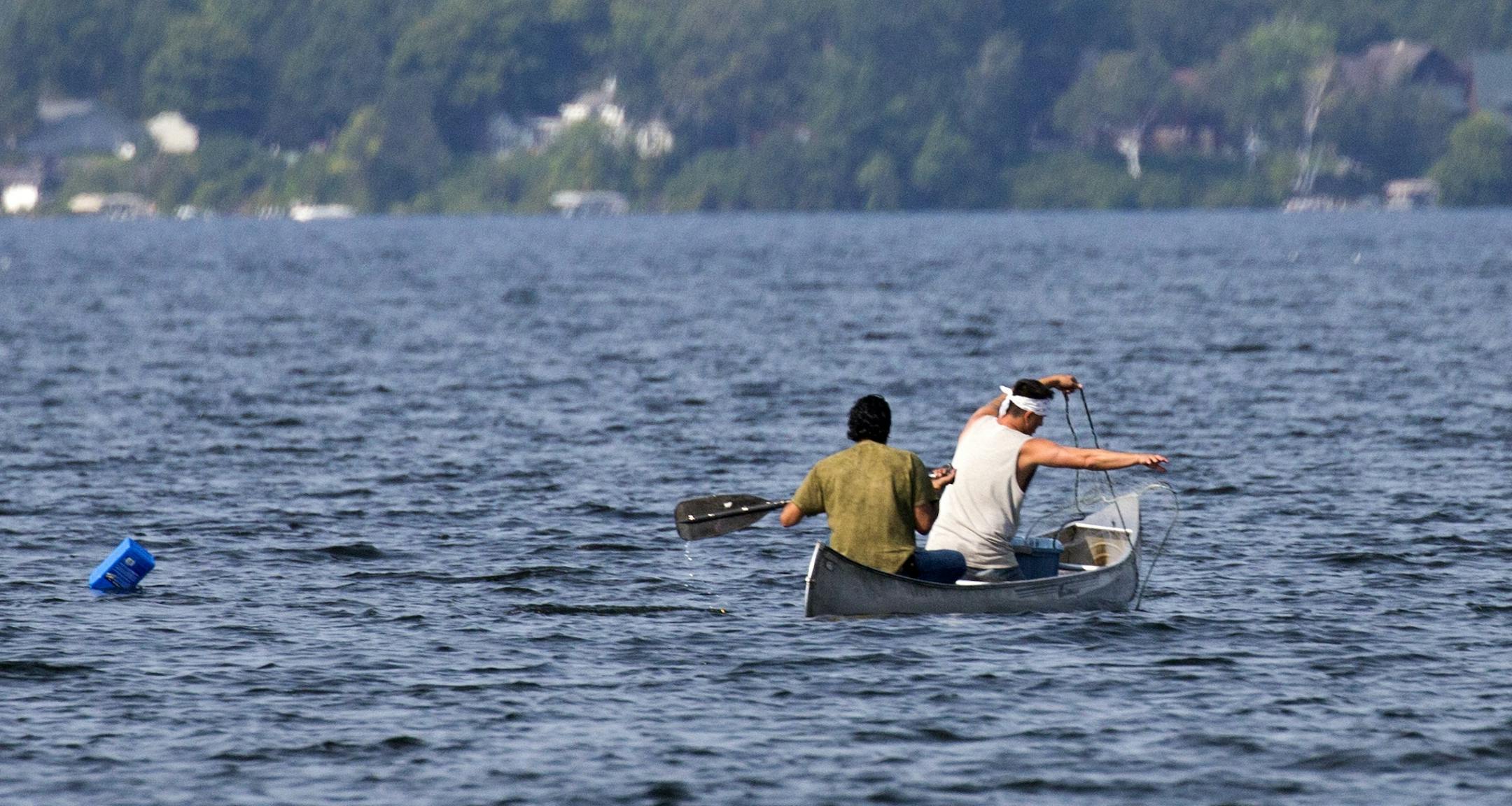 Native Americans Jim Northrup (left) and Todd Thompson, (right) set a gill net on Gull Lake Friday morning. The two were cited for Taking Fish by Illegal Methods and the DNR pulled the nets.