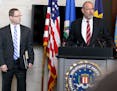 With FBI special agent Richard Thornton nearby, U.S. Attorney Andrew Luger announces that no federal criminal civil rights charges will be filed again
