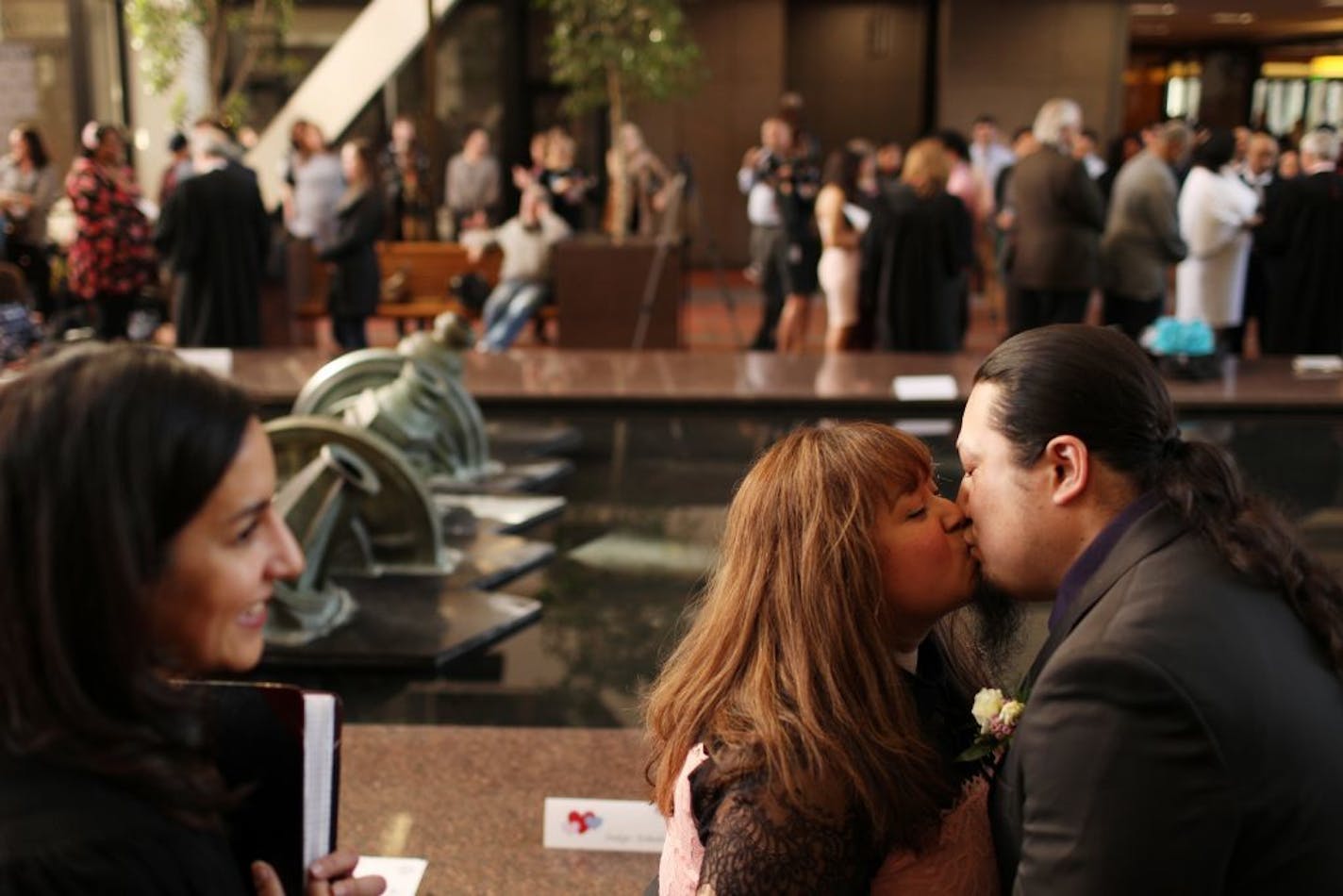 Cardina Esparza and Thomas Draskovic kissed after their wedding ceremony on Valentine's Day at the Government Center.