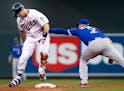 Joe Mauer (7) was tagged out by Troy Tulowitzki (2) after stepping off the bag while trying to advance to second base after hitting an RBI single in t