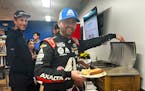 Driver William Bryon makes a hot dog at Phoenix Raceway in Avondale, Ariz. on Thursday
