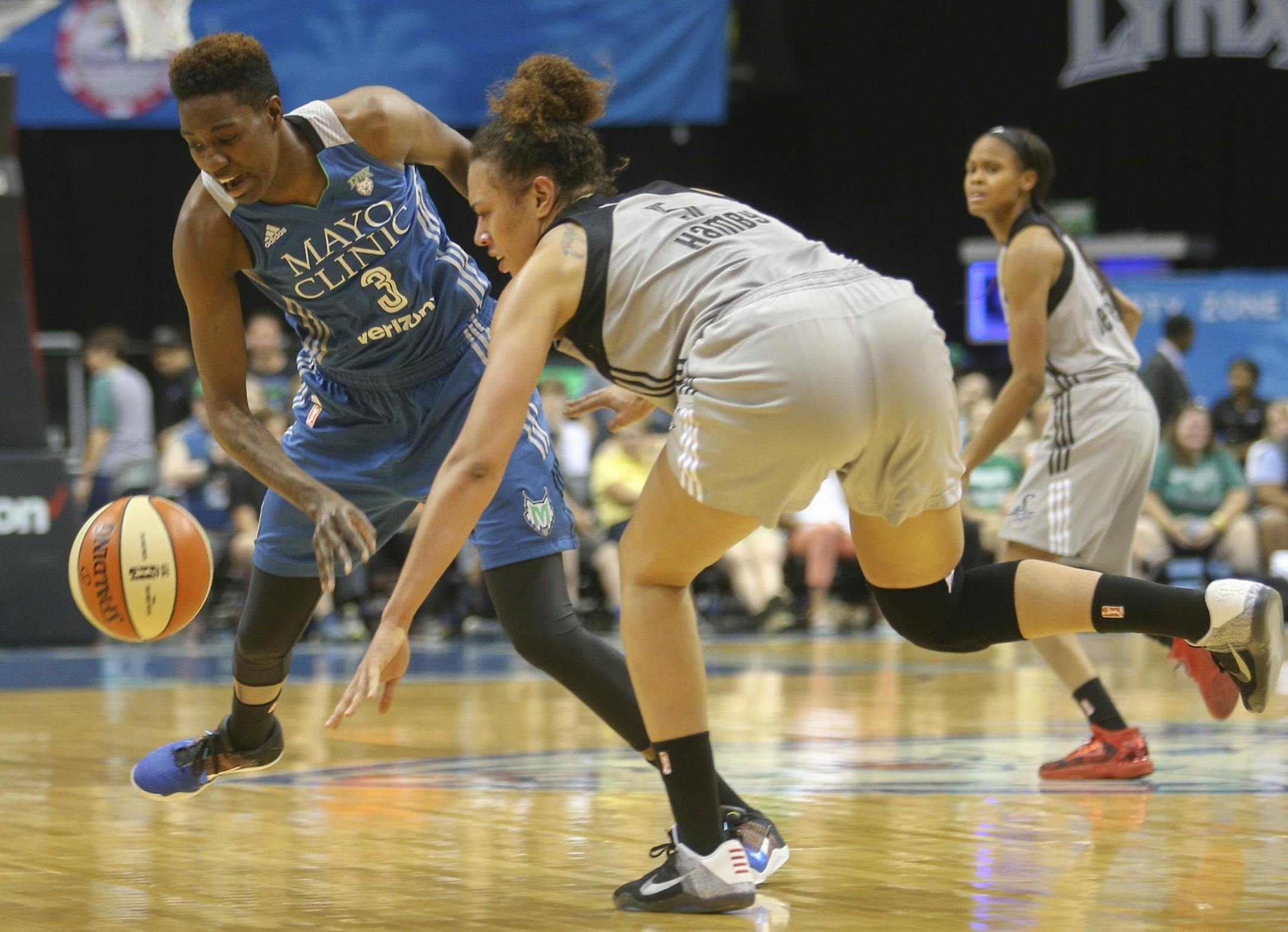Minnesota Lynx forward Natasha Howard (3) forces a steal from San Antonio Stars forward Dearica Hamby (5).