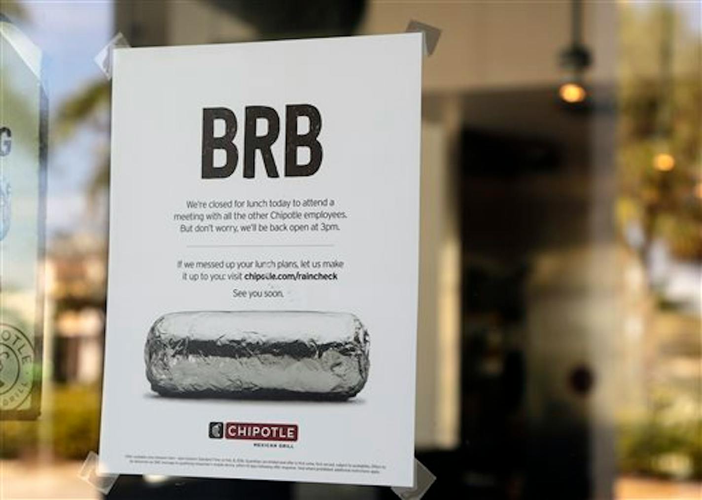 A sign on the door of a Chipotle restaurant indicates the store is closed until 3 p.m. Monday, Feb. 8, 2016, in Delray Beach, Fla. The fast-casual Mexican food chain is holding a company-wide safety briefing after outbreaks of norovirus and E. coli sickened customers last year. (AP Photo/Lynne Sladky)