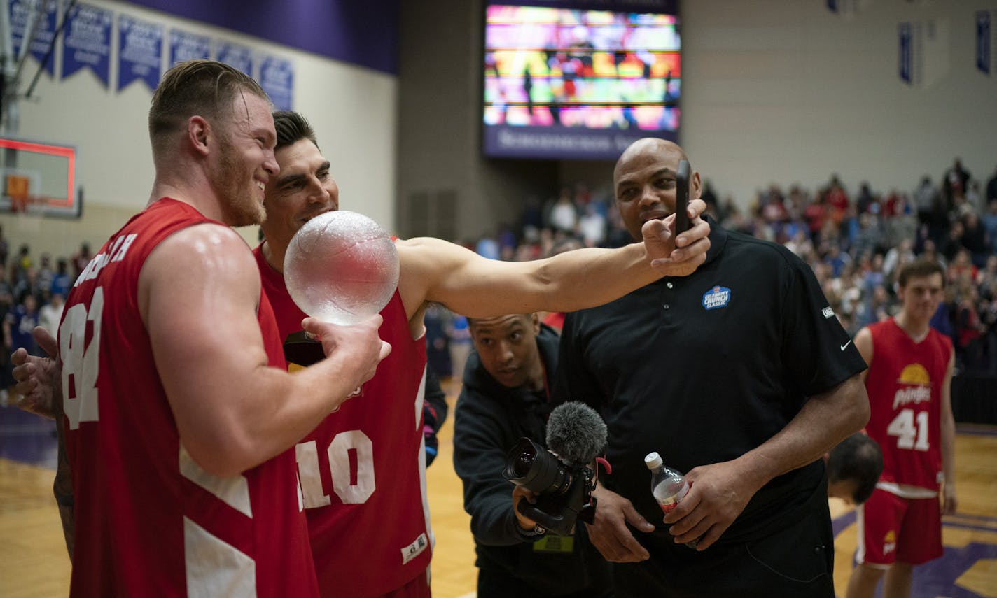 Wally Szcerbiak took a selfie with Kyle Rudolph, left, who was holding his game MVP trophy after the game near their coach, Charles Barkley. ] JEFF WHEELER &#x2022; jeff.wheeler@startribune.com The Celebrity Crunch Classic was held in Schoenecker Arena on the University of St. Thomas campus in St. Paul Sunday afternoon, April 7, 2019. Vikings tight end Kyle Rudolph was able to show off his considerable basketball skills for his Team Pringles coach, Charles Barkely. Team Pringles prevailed 69-66.