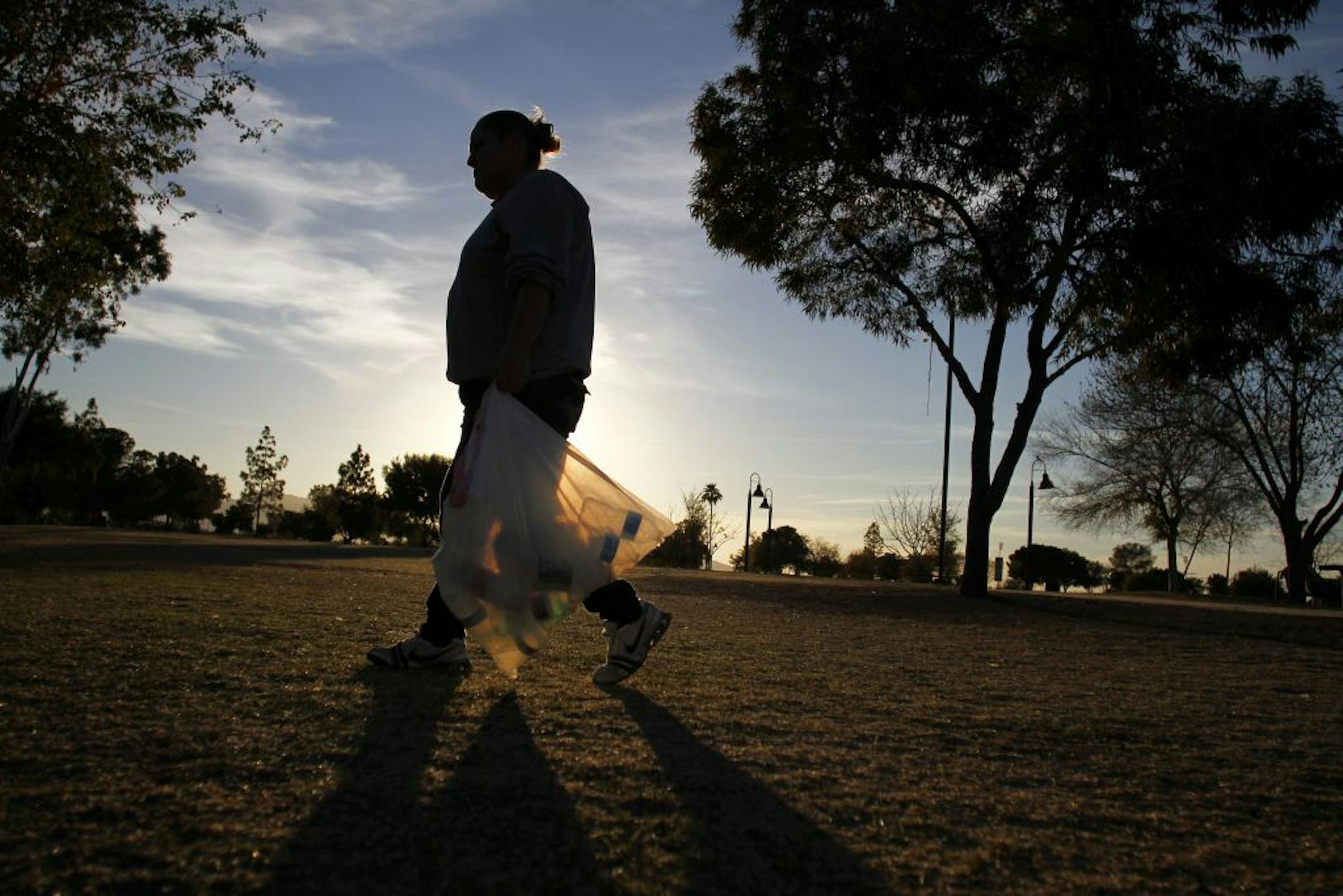 An illegal immigrant from Mexico, the mother of four American-born children, collects bottles and can after she lost her $164 of monthly government aid, in Phoenix, Feb. 23, 2012.