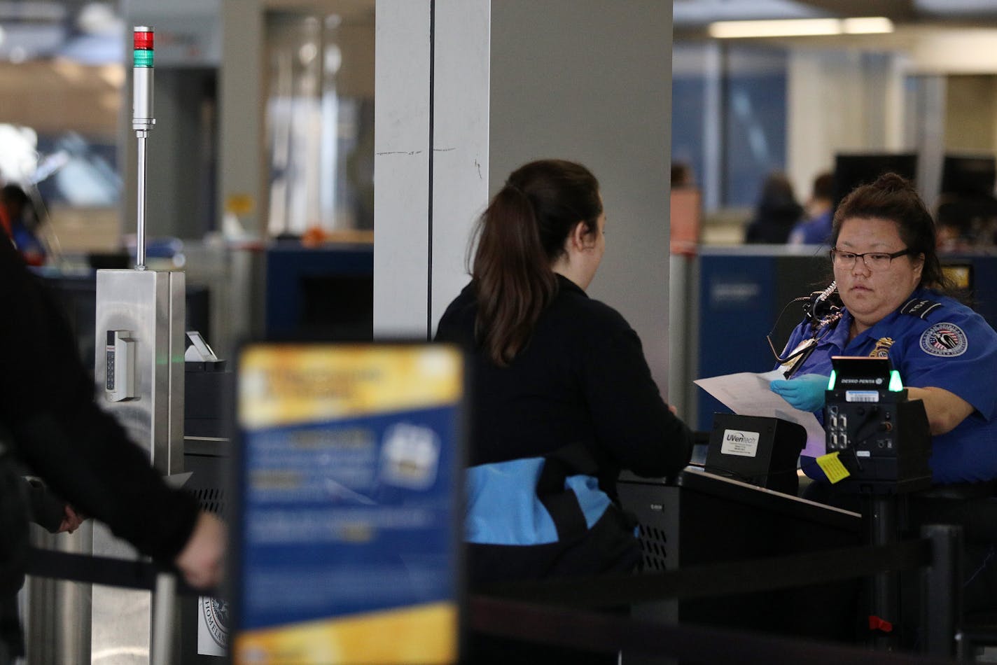 A TSA agent looked over a traveler's documents at a security checkpoint Saturday. ] ANTHONY SOUFFLE &#x2022; anthony.souffle@startribune.com Officials have said security was heightened Saturday, Jan. 7, 2016 at Minneapolis St. Paul International Airpot in the days following an attack by a gunman at the Fort Lauderdale-Hollywood International Airport that left five people dead and six others wounded.