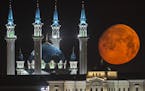 The full moon rises over the illuminated Kazan Kremlin with the Qol Sharif mosque illuminated in Kazan, the capital of Tatarstan, located in Russia's 