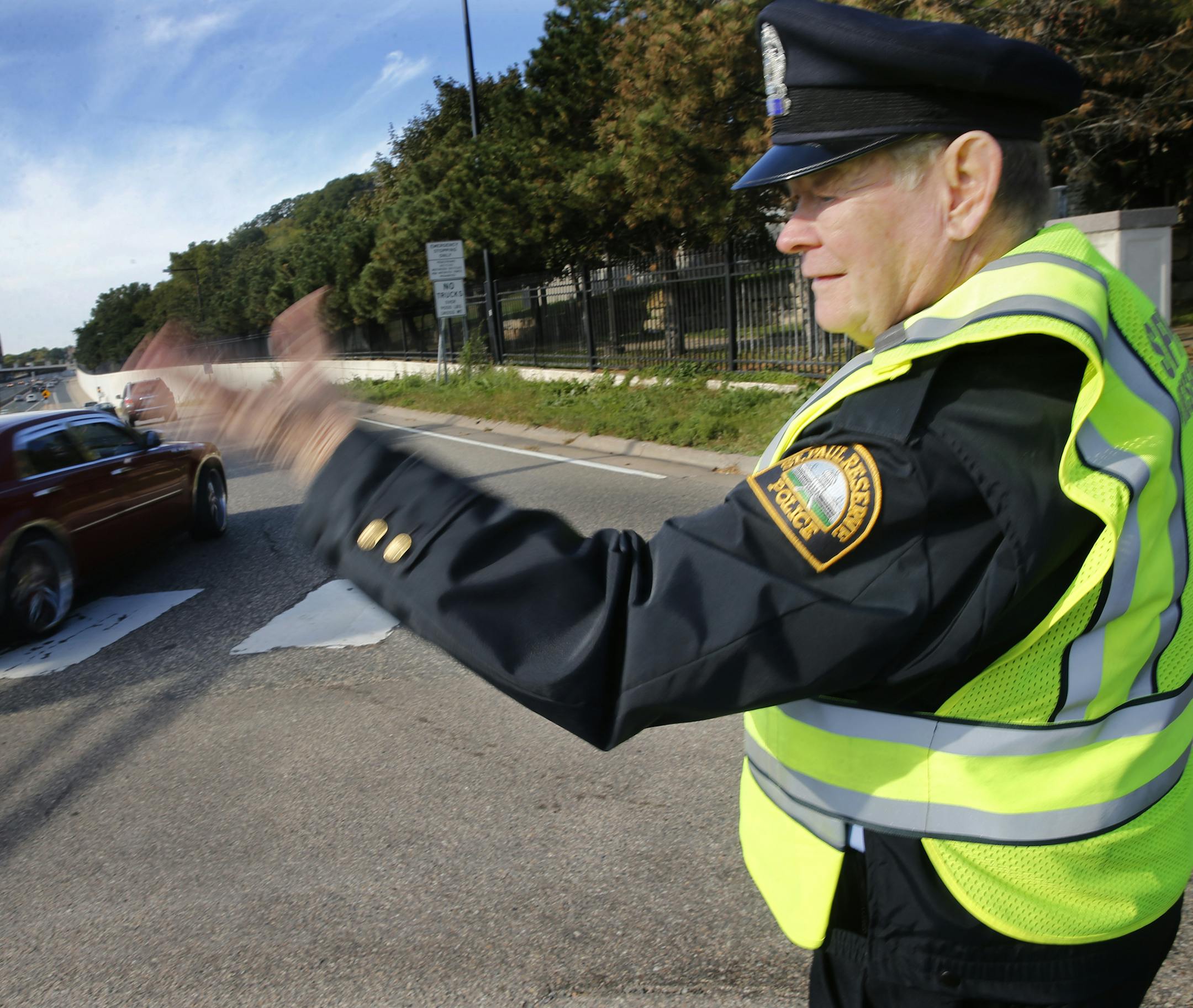 Near the finish of the Medtronics Twin Cities Marathon, Pat Willis directs traffic. He graduated from St. Paul Central High School in 1958. He married his wife, Peggy, 50 years ago this past August. He turns 75 next month. and has been an officer with the St. Paul Police Reserves since 1967.] Richard Tsong-Taatarii/rtsong-taatarii@startribune.com