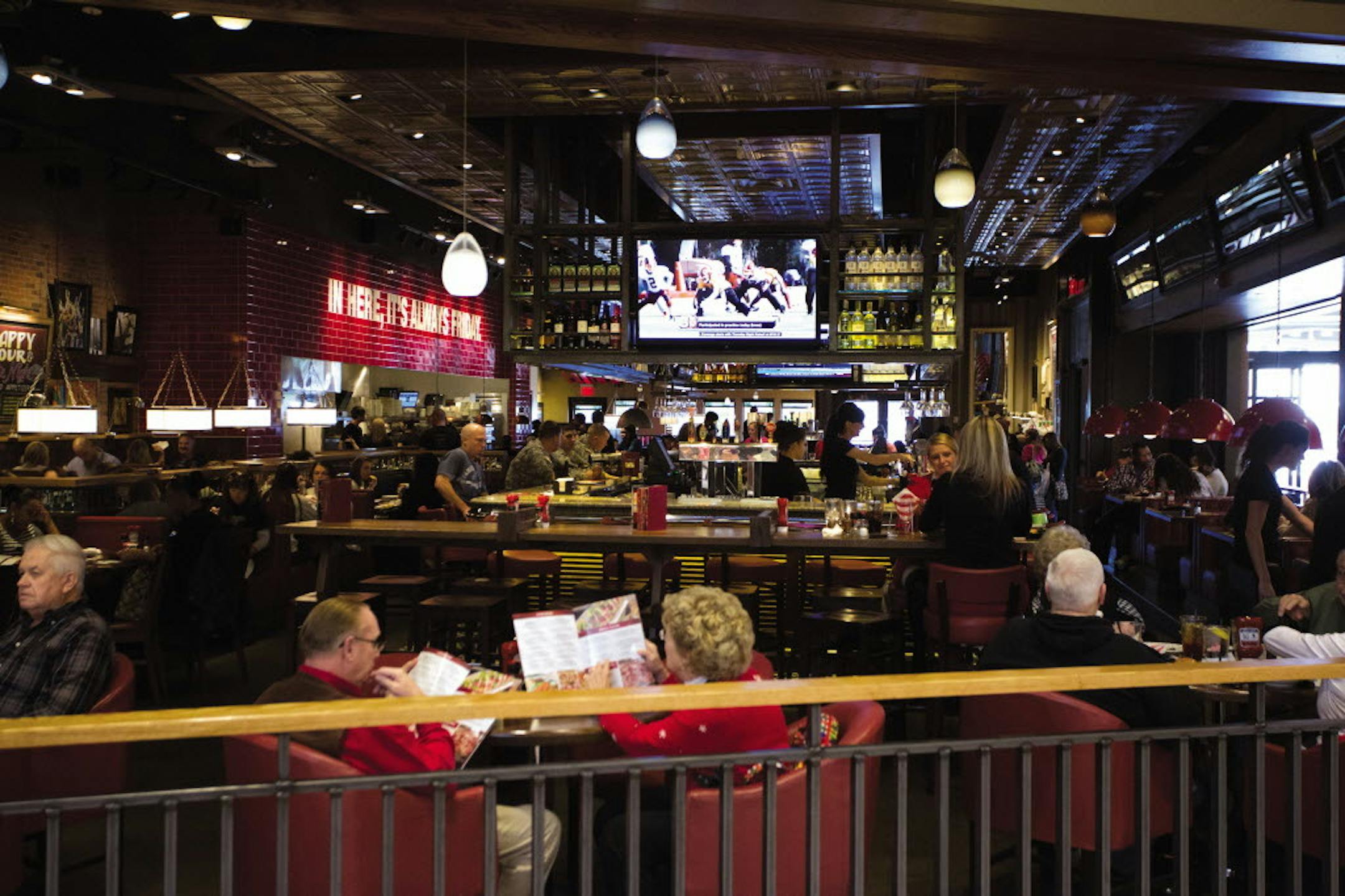 The interior of the new TGI Friday's restaurant in Nashville has plush leather seats, solid wood tables and the marble-topped bar, the center of attention.