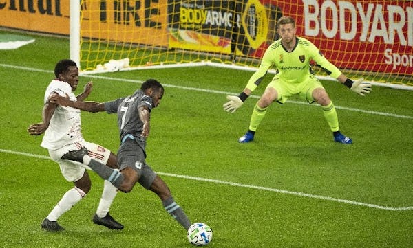 Minnesota United midfielder Kevin Molino (7) took a second-half shot on Real Salt Lake goalkeeper Zac MacMath while being defended closely by Nedum On