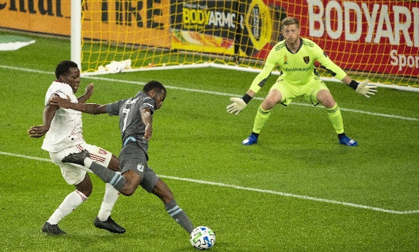 Minnesota United midfielder Kevin Molino (7) took a second-half shot on Real Salt Lake goalkeeper Zac MacMath while being defended closely by Nedum Onuoha (14). The Loons won 4-0.