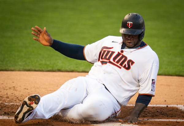 Minnesota Twins first baseman Miguel Sano (22) slid into home for a run on a double hit by Minnesota Twins catcher Ryan Jeffers (27) in the first inni