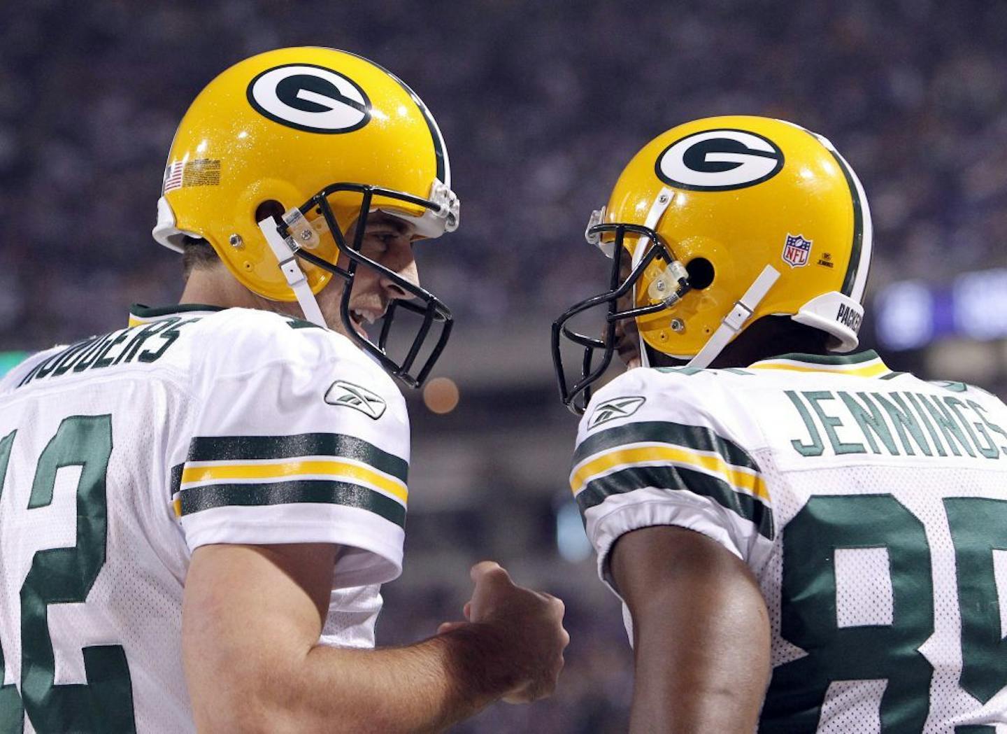 Aaron Rodgers (12) and Greg Jennings (85) celebrated after they connected on a 46-yard catch and run. Green Bay beat Minnesota by a final score of 31-3.