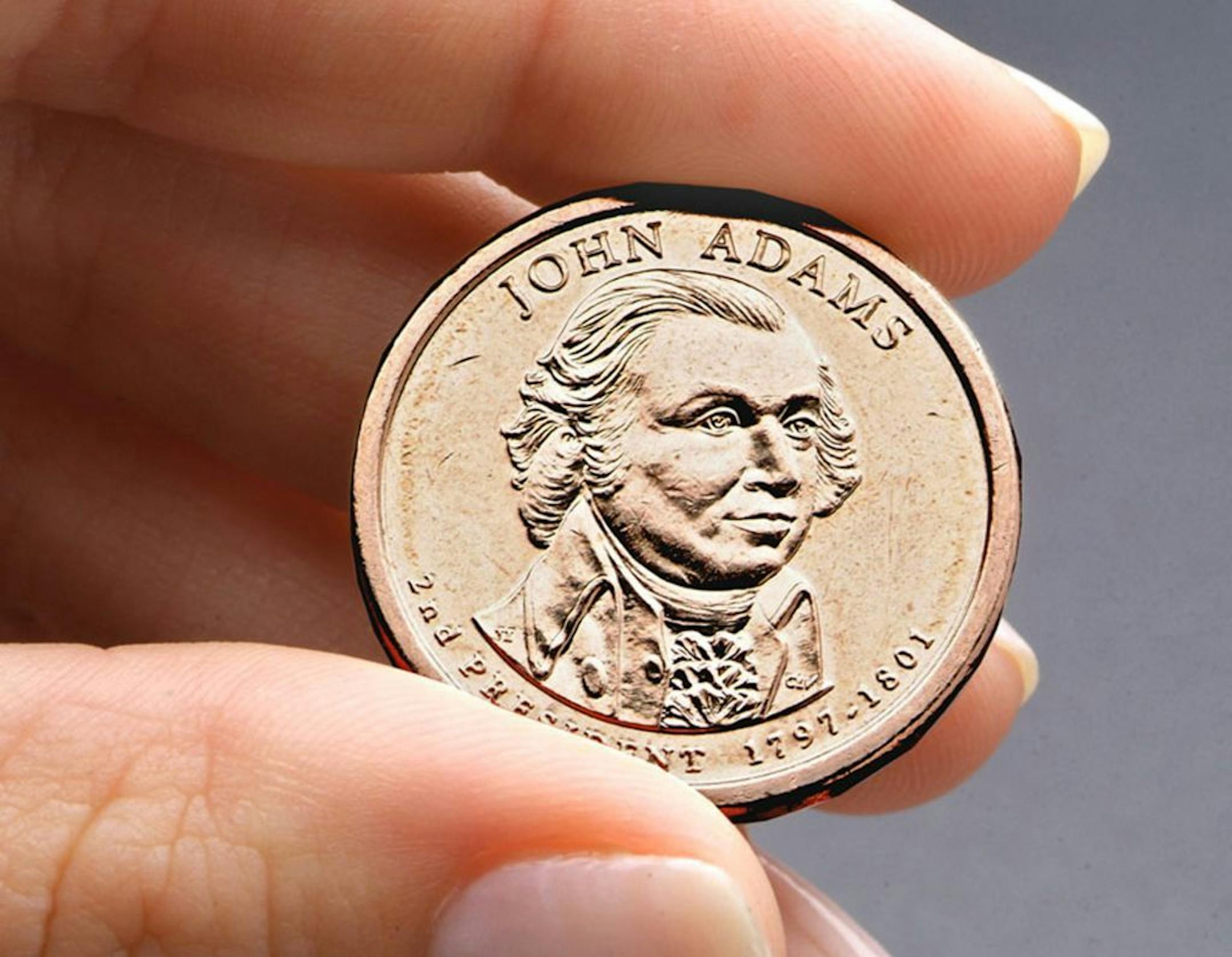 FILE - This undated file photo provided by the U.S. Mint shows the President John Adams presidential $1 coin. Congressional auditors say doing away with dollar bills entirely and replacing them with dollar coins could save taxpayers some $4.4 billion over the next 30 years.