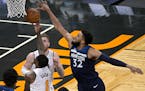 Minnesota Timberwolves center Karl-Anthony Towns (32) blocks a shot by Orlando Magic guard Dwayne Bacon (8) during the first half of an NBA basketball
