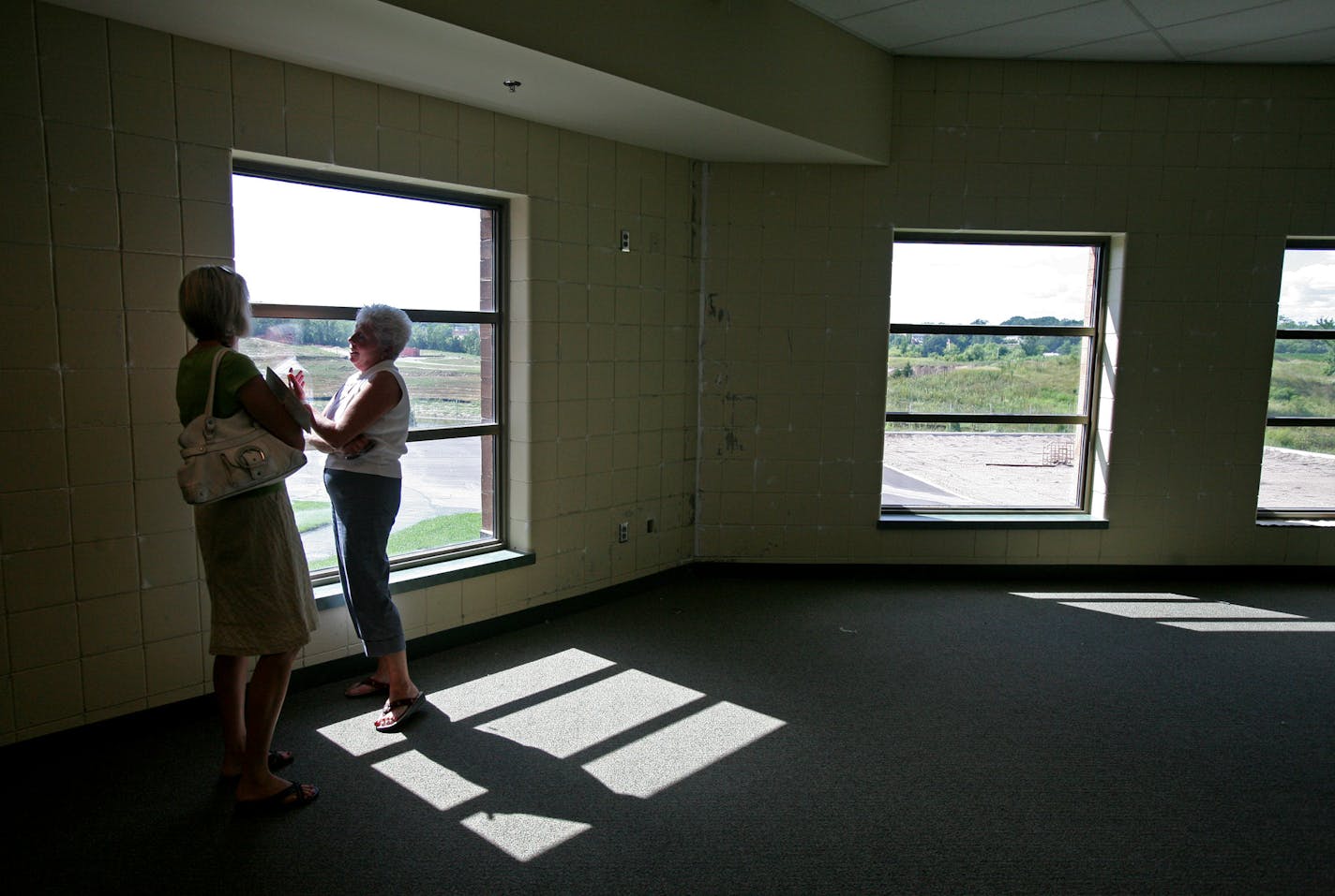 Glendale Elementary School Principal Pam Becker, right, gave a tour of Redtail Ridge Elementary to Kristi Mussman, the Prior Lake-Savage district's communications coordinator. Becker was supposed to have been the principal of the school, which will stand empty this year.