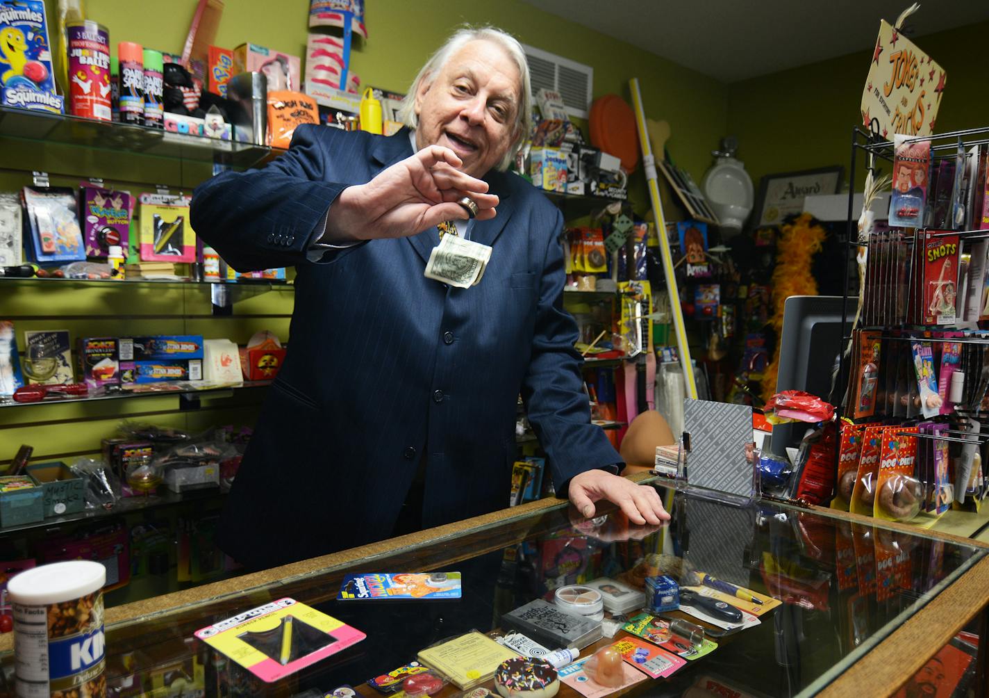 Larry Kahlow, of Eagle Magic, demonstrated the dollar snatcher gag. Photo by Liz Rolfsmeier, Special to the Star Tribune