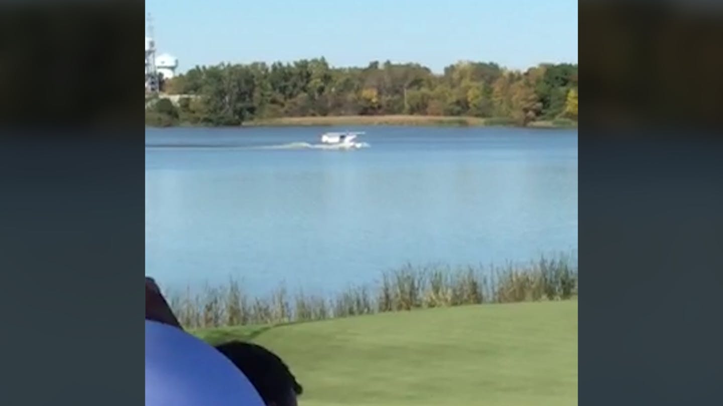 In this screengrab from cell phone video a floatplane pilot and passenger are seen landing on Lake Hazeltine adjacent of the 7th hole on Sunday.