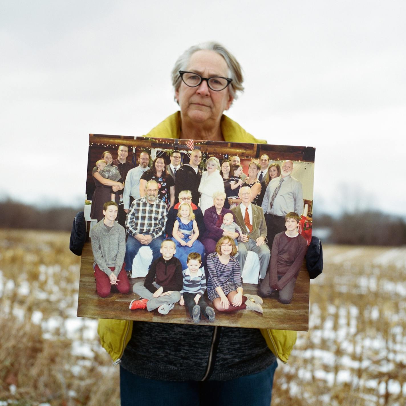 Chief Medical Examiner Patty Schachtner holds a group portrait of her family in St. Croix County, Wis., on Sunday, Nov. 15, 2020. The coronavirus pandemic was a faraway nightmare when Schachtner began preparing.