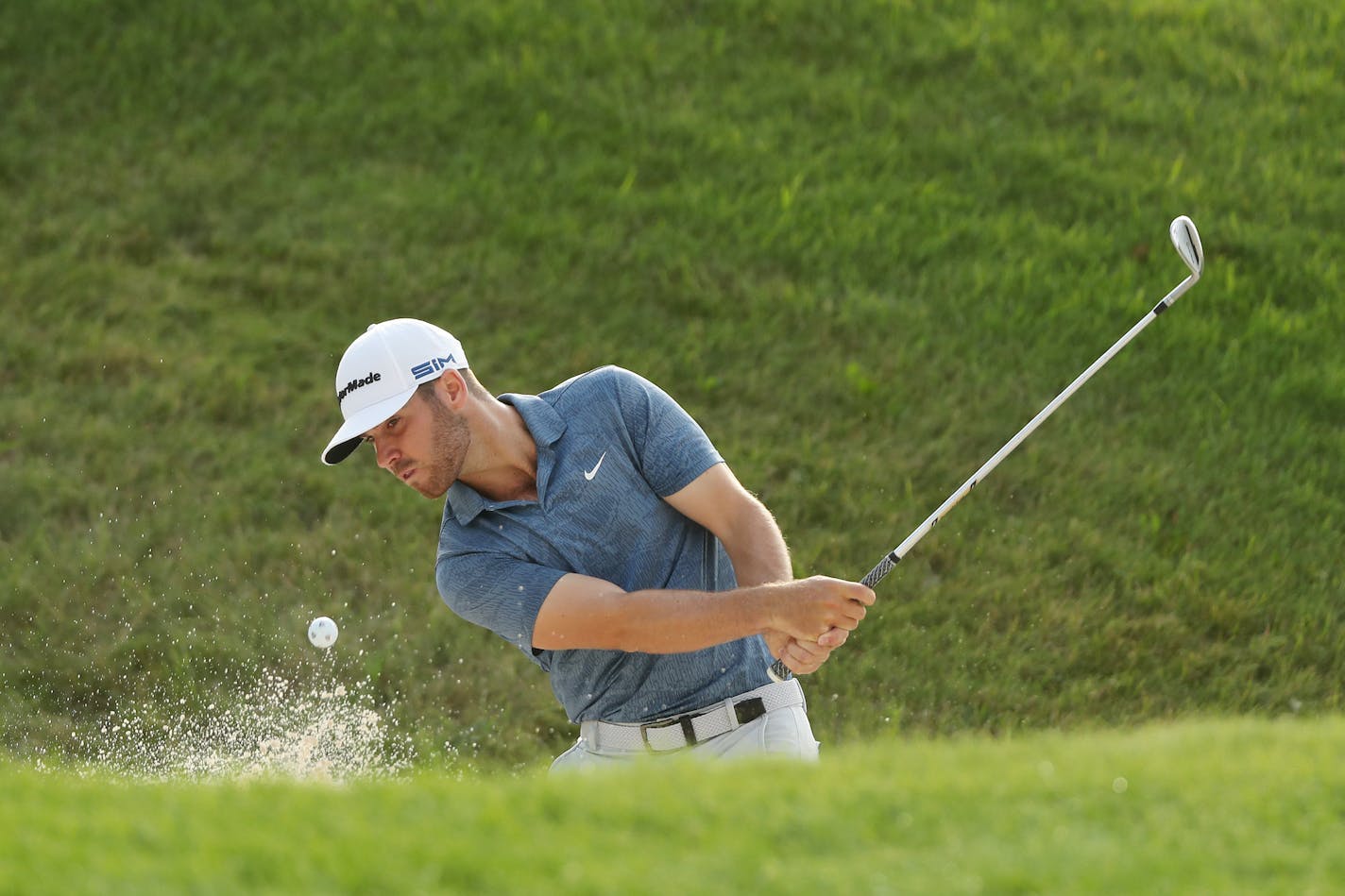 Matthew Wolff plays a shot from a bunker on the 12th hole during the second round of the 3M Open