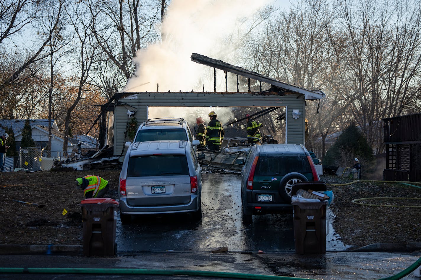 Fire crews work to put out a fire after a house explosion that killed at least two people and destroyed a home in South St. Paul, Minn. Thursday, Nov. 30, 2023. ] LEILA NAVIDI • leila.navidi@startribune.com