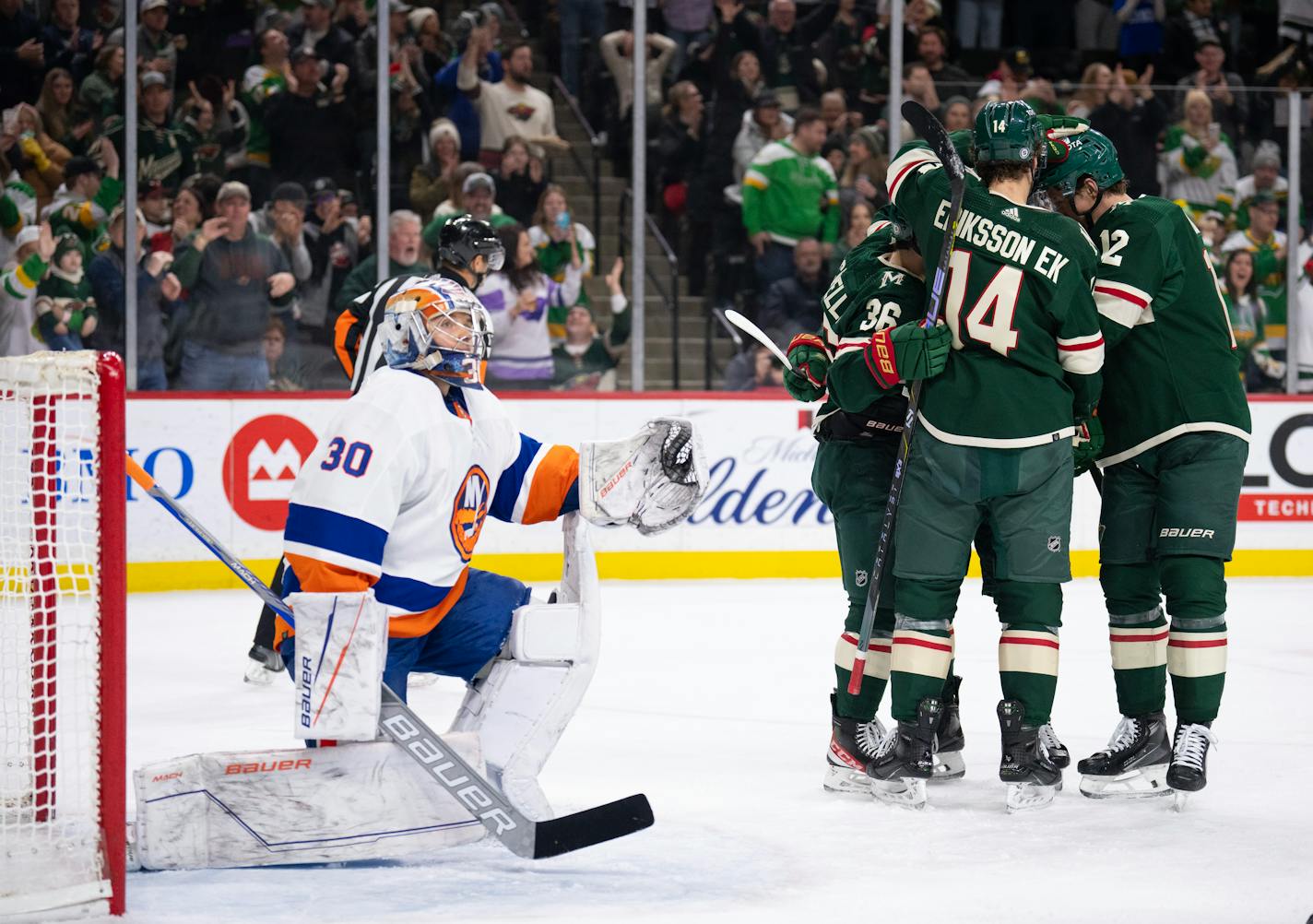 Minnesota Wild center Joel Eriksson Ek (14) was congratulated after he scored in the second period. Eriksson Ek scored again in the third as the Minnesota Wild shut out the New York Islanders 5-0 in an NHL hockey game Monday night, January 15, 2023 at Xcel Energy Center in St. Paul. ] JEFF WHEELER • Jeff.Wheeler@startribune.com