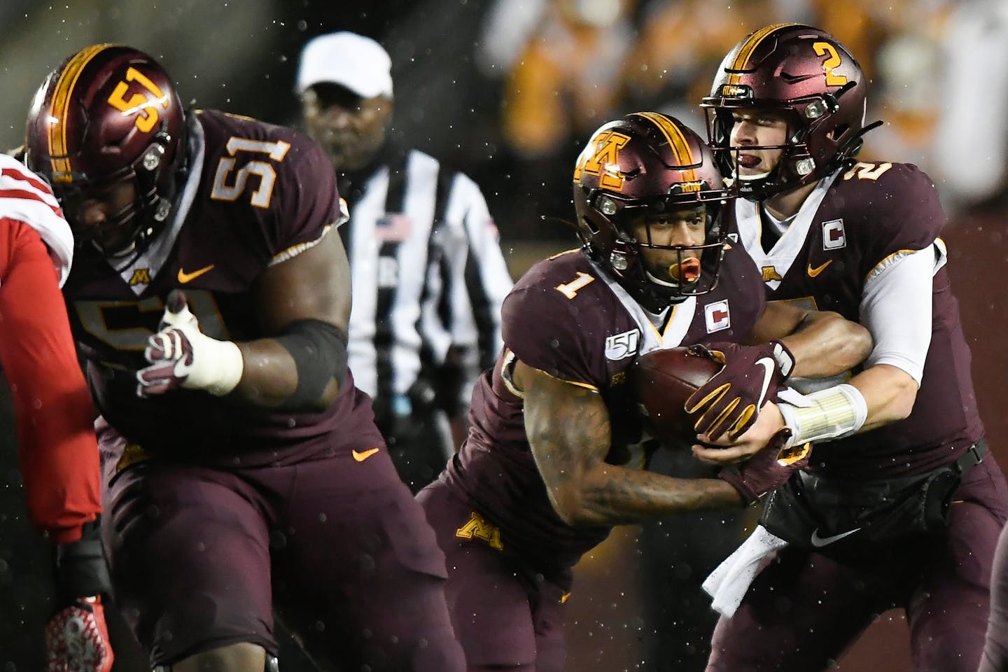 Right guard Curtis Dunlap Jr. (51) cleared a path for Gophers running back Rodney Smith, taking a handoff from quarterback Tanner Morgan against Nebraska. Dunlap and the offensive line are coming off two of their best games against Illinois and Nebraska.