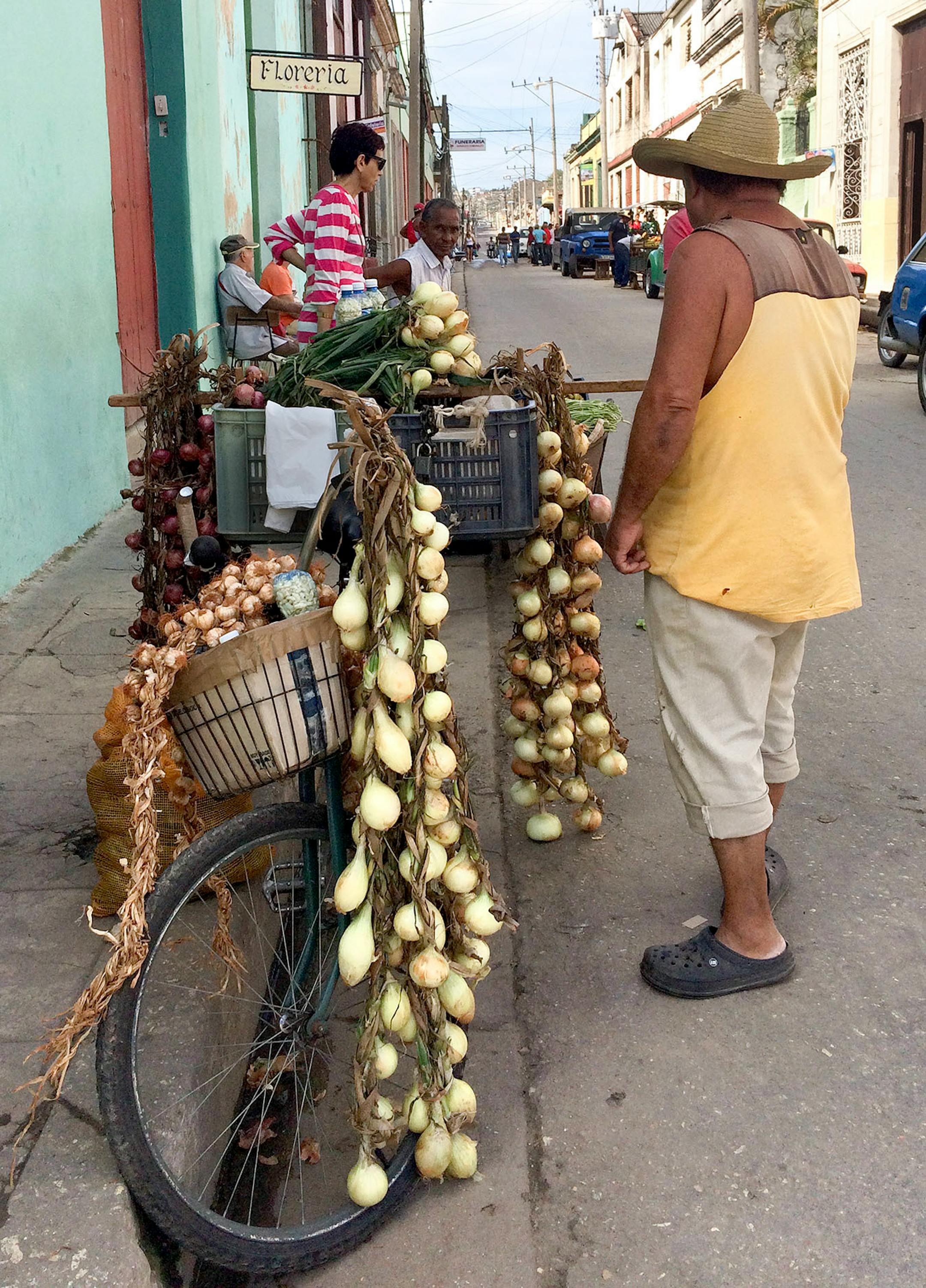 A man sells onions, garlic and avocados from a wheelbarrow and a bin placed across the handlebars of a bicycle. [ Photos by Amelia Rayno
The Minneapolis Star Tribune