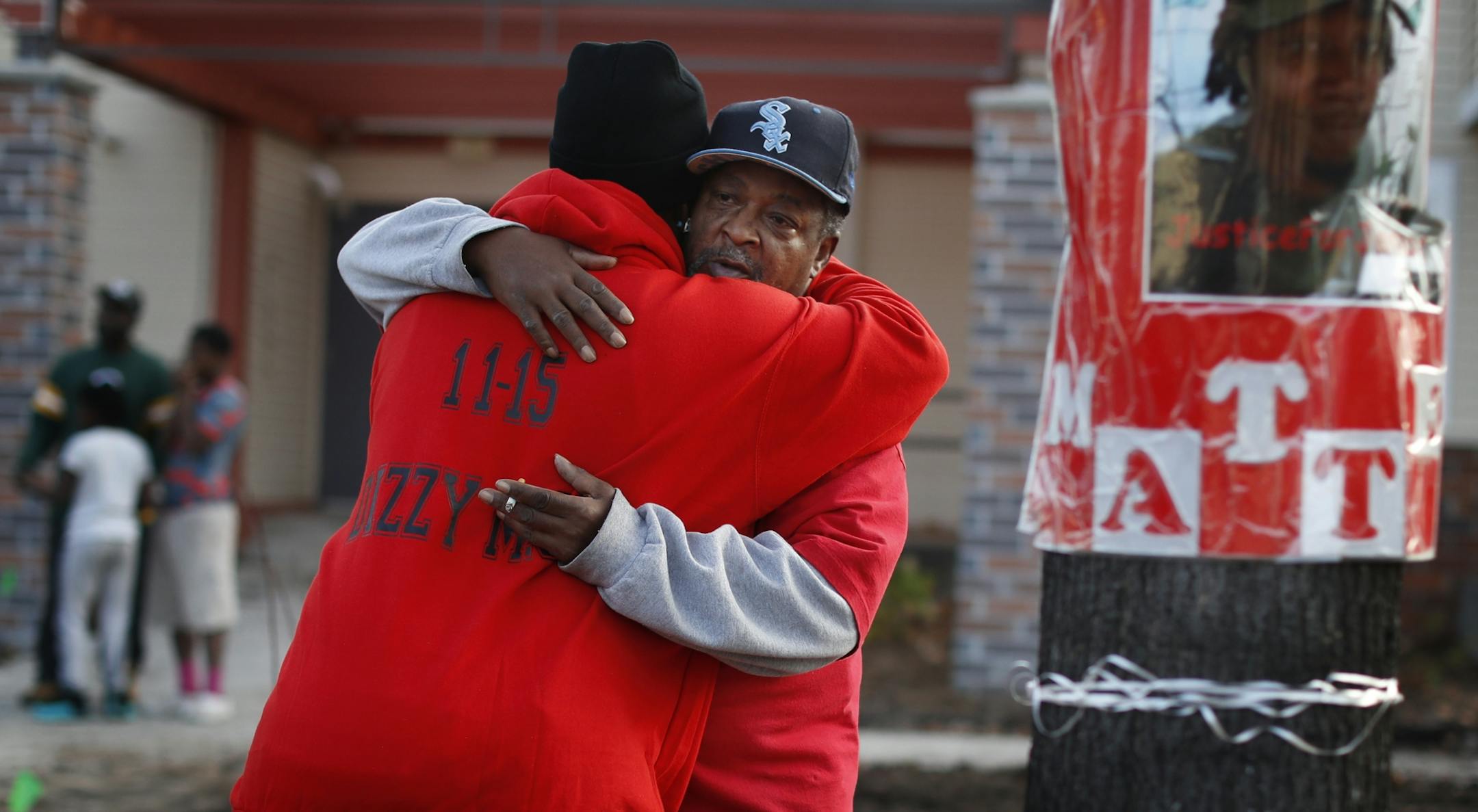 James Hill right father of Jamar Clark got a hugged from a family member as they gathered with friends and community activists near the spot where Jamar Clark was killed in a confrontation with city police last fall to commemorate his death.Tuesday October 15, 2016 in Minneapolis, MN.