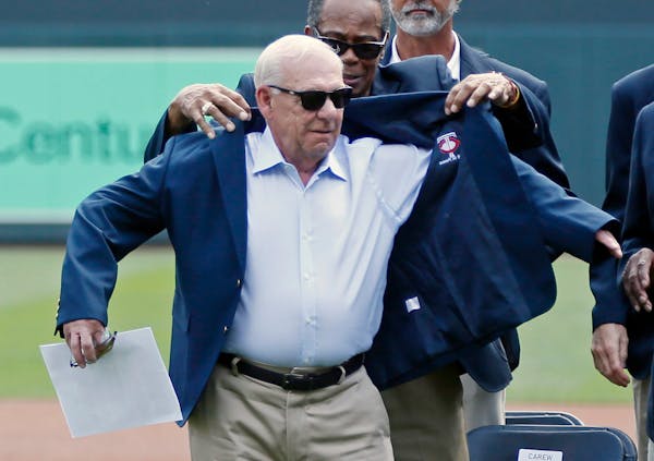 Minnesota Twins great Rod Carew helps with the jacket as Jerry Bell, left, former president of the Twins, was inducted into the Twins Hall of Fame pri