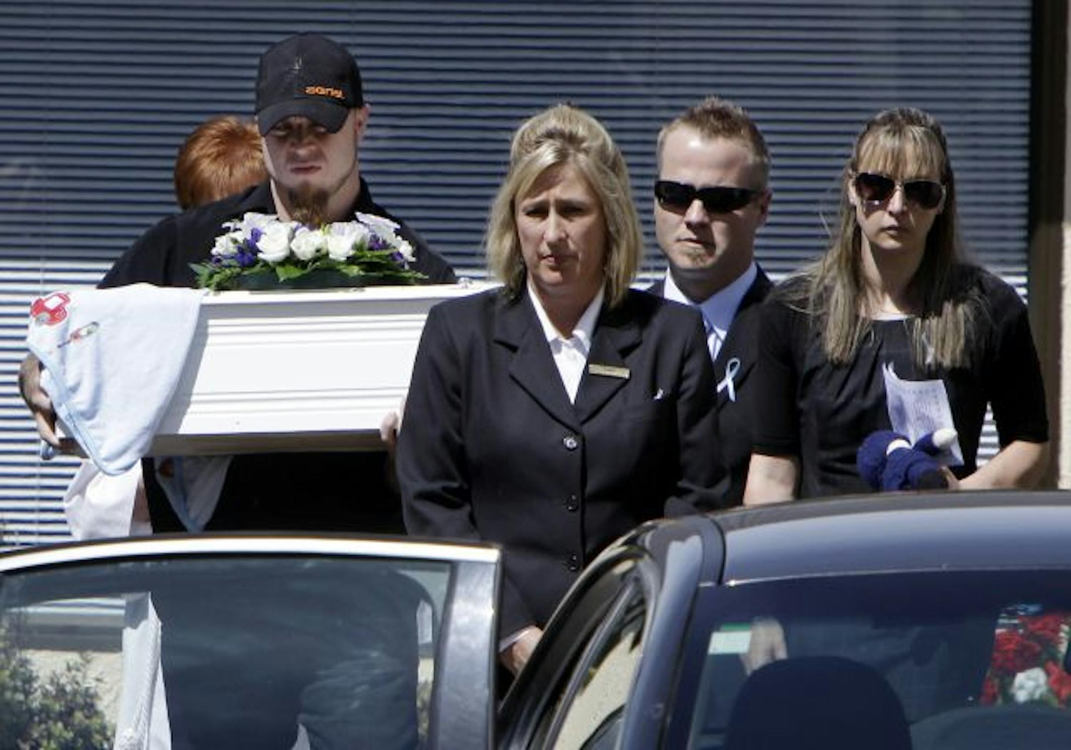 The casket of 5-month-old Baxtor Gowland was carried to a car after his funeral Monday in Christchurch, New Zealand.