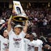 South Carolina coach Dawn Staley carries the NCAA women's college basketball title trophy around Colonial Life Arena during a team celebration April 8