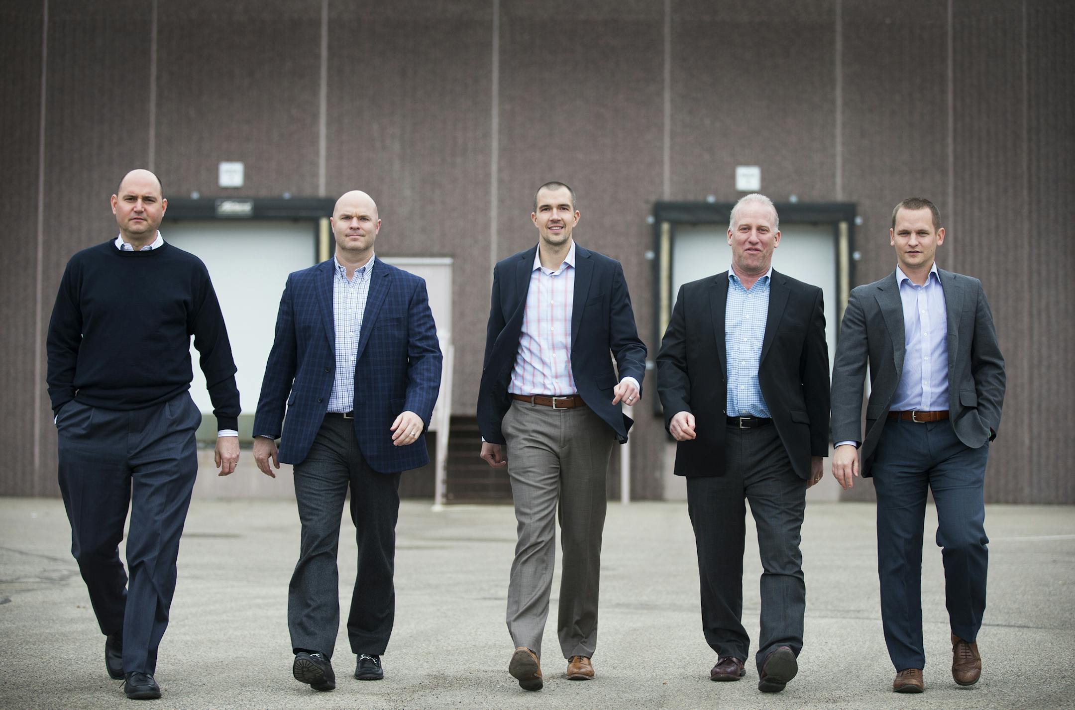 Cushman & Wakefield/NorthMarq executive directors Jason Meyer, from left, Kris Smeltzer, Brent Masica and Jon Yanta, and senior associate Hudson Brothen pose for a portrait at one of their properties in Bloomington.