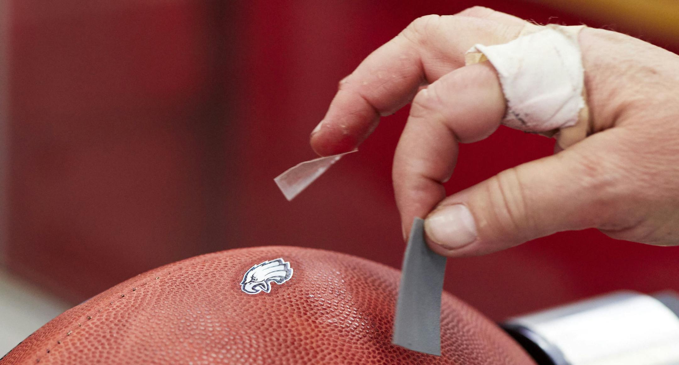 A Philadelphia Eagles logo is applied to an official team ball for the NFL Super Bowl LII football game at the Wilson Sporting Goods Co. in Ada, Ohio, Monday, Jan. 22, 2018. The New England Patriots will play the Philadelphia Eagles in the Super Bowl on Feb. 4, in Minneapolis, MN. (AP Photo/Rick Osentoski)