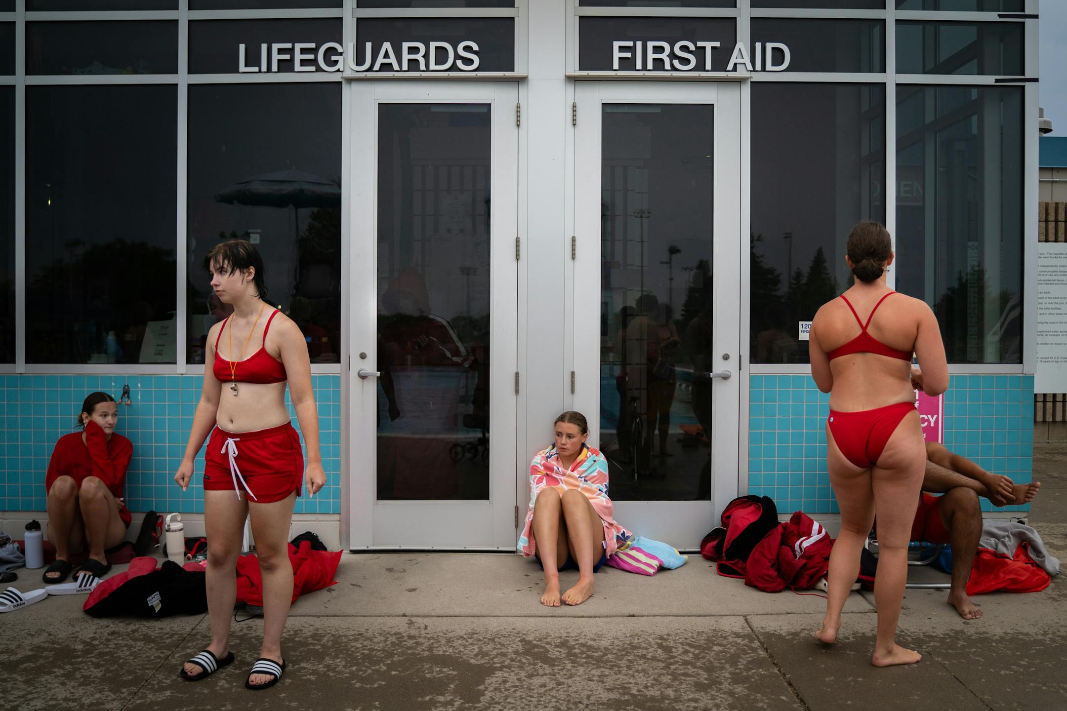 Lifeguards in training wait for the next drill during lifeguard lessons at the Bloomington Family Aquatic Center.