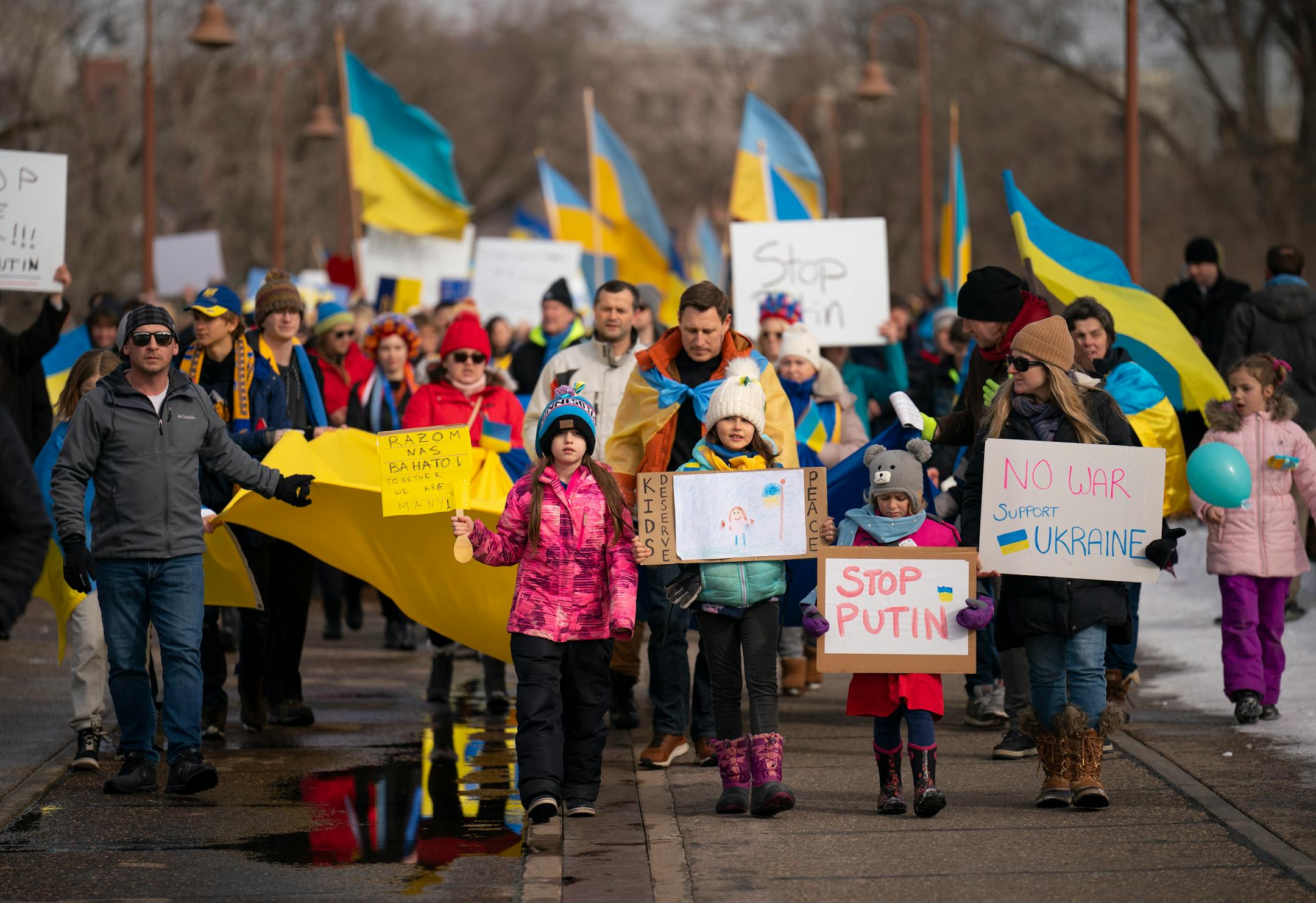 Ukraine supporters marched on the Stone Arch Bridge towards a group of Belarusians in a show of support for Ukraine Sunday afternoon, February 27, 2022 in Minneapolis, Minn. Hundreds of supporters of the people of Ukraine met a few dozen supporters of the Belarusian people midway across the Stone Arch Bridge in Minneapolis before continuing on a march together across the Hennepin Ave. bridge to Northeast Minneapolis where the march first began. ] JEFF WHEELER • Jeff.Wheeler@startribune.com