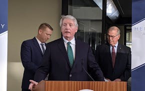 Minnesota Department of Commerce Commisioner Steve Kelley speaks at a morning news conference about felony charges against Leroy and Joyce Merit, who 