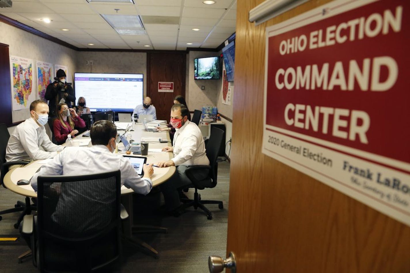 Ohio Secretary of State Frank LaRose, front, interacts with staff members as they follow the election from Ohio's election command center Tuesday, Nov. 3, 2020, in Columbus, Ohio.