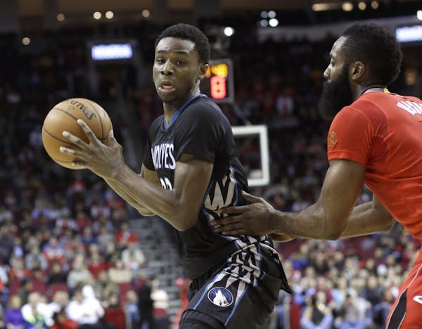 The Timberwolves' Andrew Wiggins tried to make a move on the Rockets' James Harden in the first half Monday night.