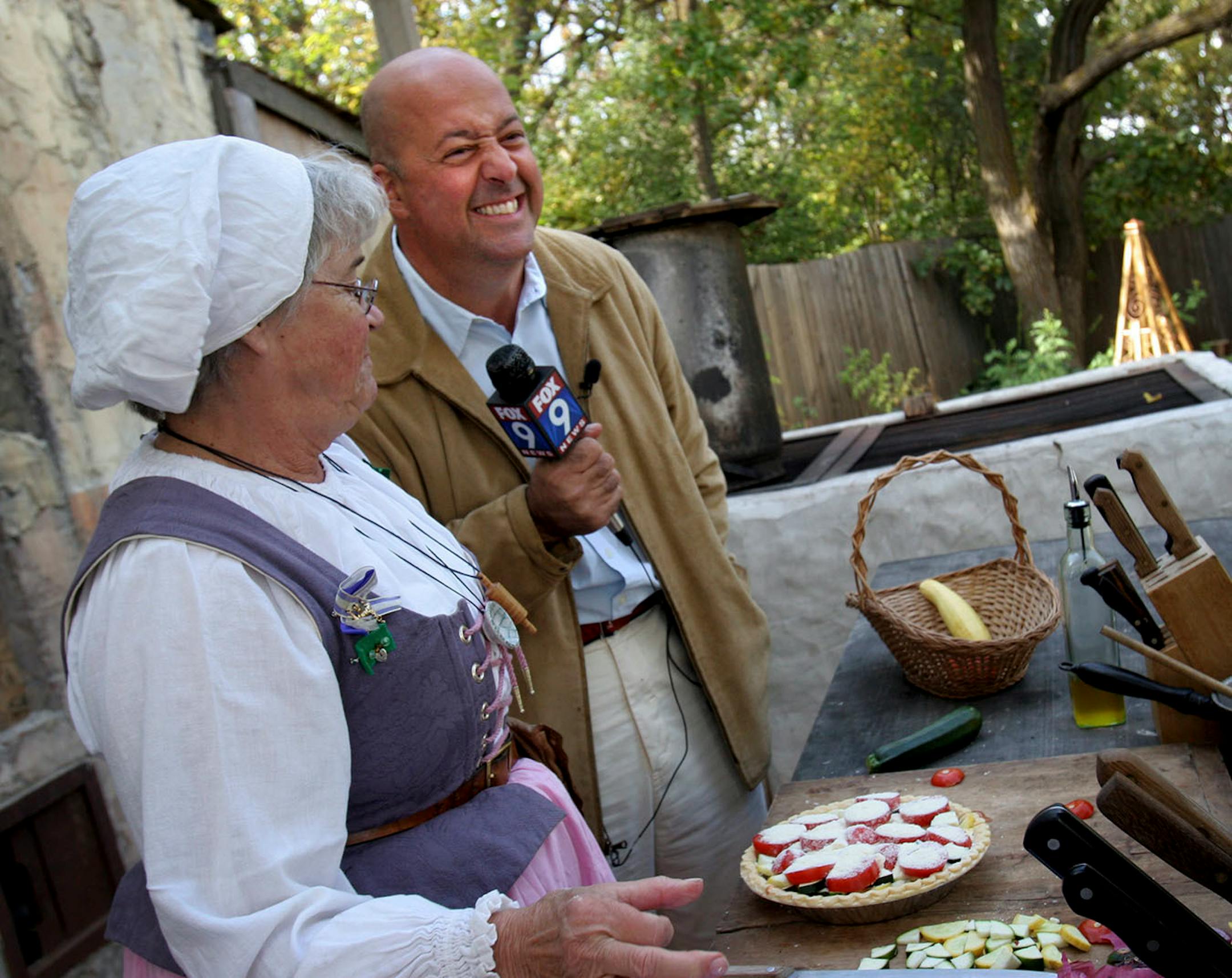 Andrew Zimmern cheesed for the camera after flubbing a line when talking to Renaissance Festival demonstration cook Janet Cardle.
