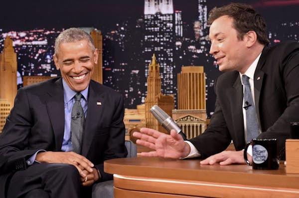 President Barack Obama, left, laughs while listening to host Jimmy Fallon on the set of the "The Tonight Show Starring Jimmy Fallon," at NBC Studios i