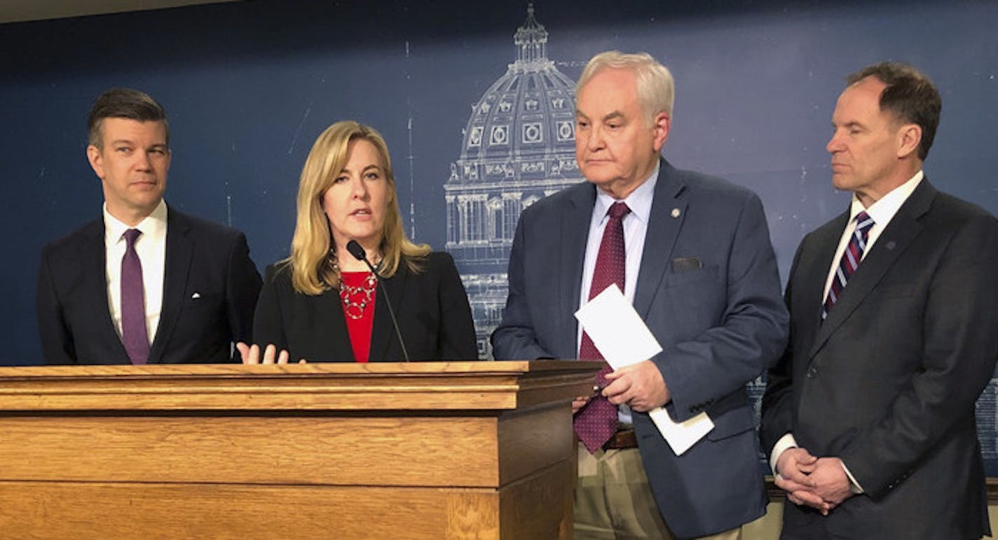 Minnesota House Speaker Melissa Hortman, center, unveils the House Democratic budget framework on Monday, March 25, 2019, at the state Capitol in St. Paul. Joining her for the announcement from left, are, Majority Whip Liz Olson, Majority Leader Ryan Winkler, Hortman, Ways and Means Committee Chairman Lyndon Carlson, Taxes Committee Chairman Paul Marquart and Higher Education chair Connie Bernardy. House Democrats have unveiled a budget framework that's similar to Democratic Gov. Tim Walz's prop