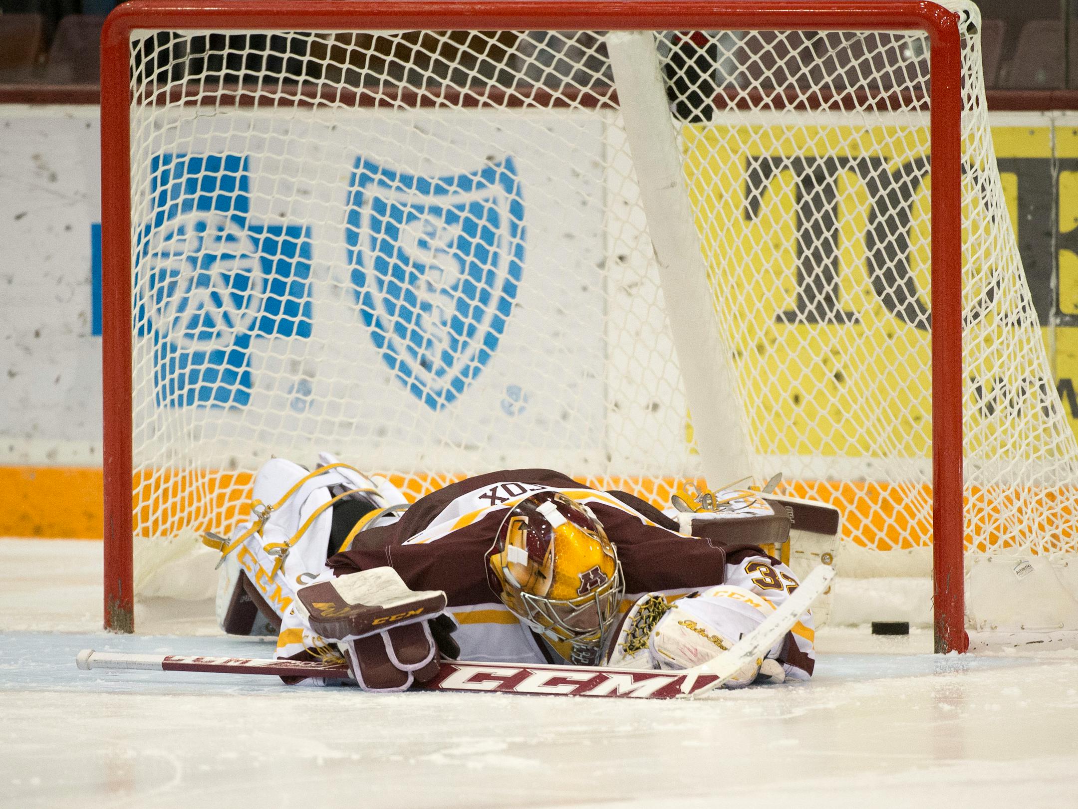 University of Minnesota goalie Adam Wilcox (32) lays down on the ice after University of Wisconsin won the game during a shoot. (Aaron Lavinsky | StarTribune) The University of Minnesota Gophers hockey team plays against the Wisconsin Badgers on Friday, Jan. 16, 2015 at Mariucci Arena.