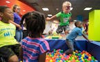 Connor Deibel (cq), 3, leapt into a ball pit while playing with other children during the grand opening celebration of "Drop 'n Shop" Friday at Mall o