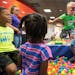 Connor Deibel (cq), 3, leapt into a ball pit while playing with other children during the grand opening celebration of "Drop 'n Shop" Friday at Mall o