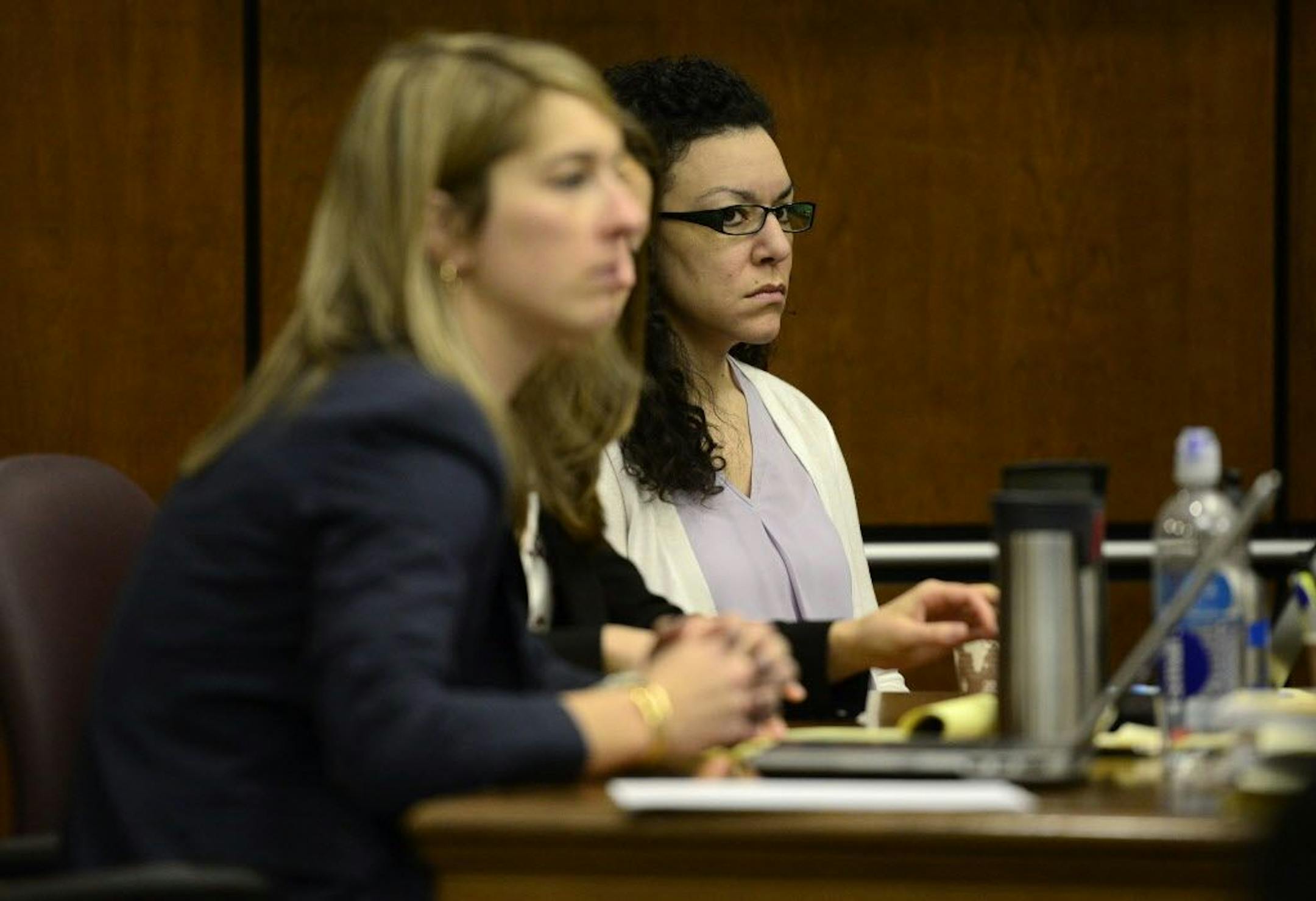 Dynel Lane, right, listens besides her defense attorneys, during her trial Friday, Feb. 19, 2016, in Boulder, Colo. Lane is charged with attempted first-degree murder, assault and unlawful termination of a pregnancy in the 2015 attack on Michelle Wilkins in Longmont, Colo. (Matthew Jonas/Daily Camera via AP) NO SALES; MANDATORY CREDIT