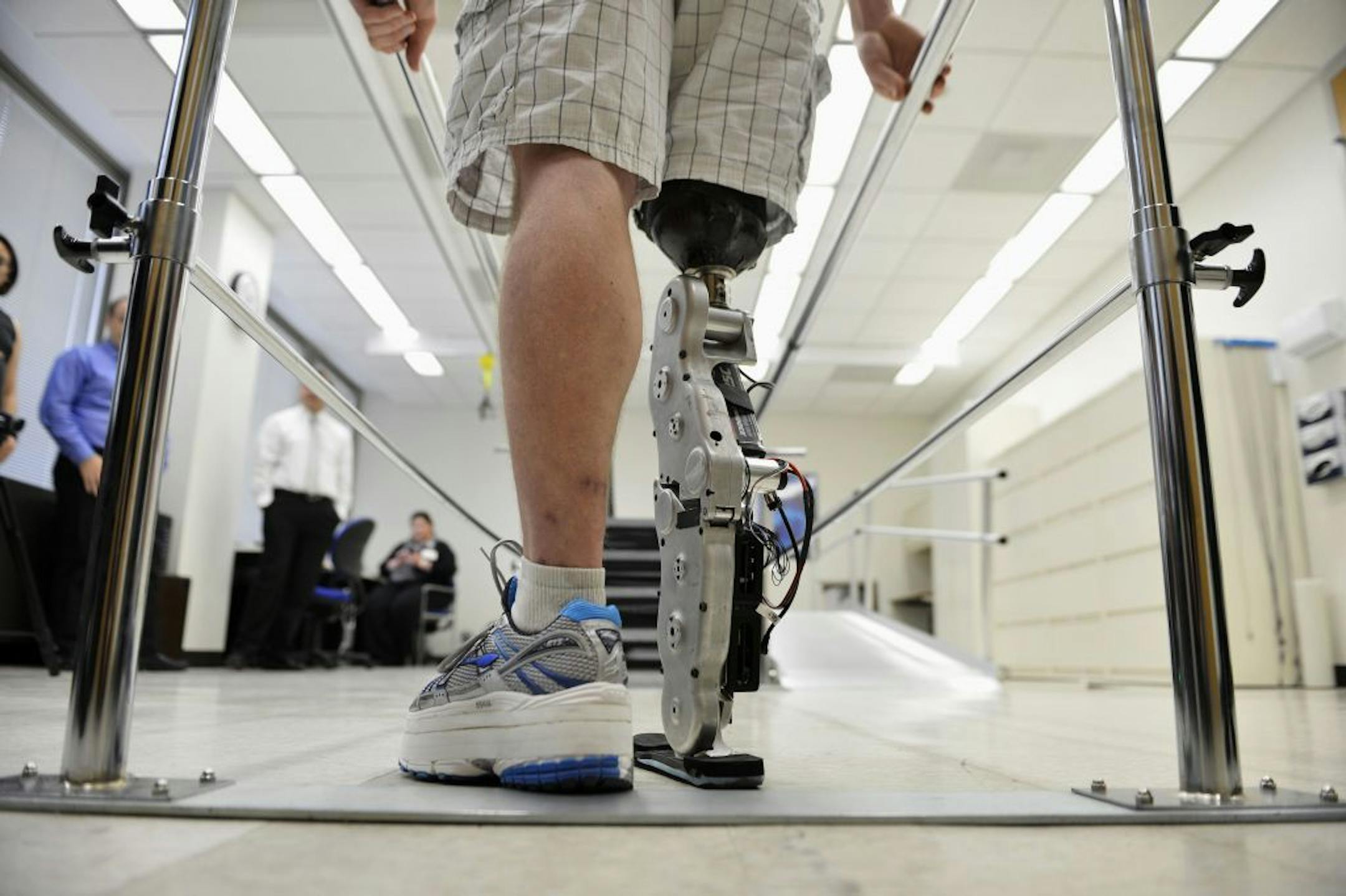 In this Oct. 25, 2012 photo, Zac Vawter practices walking with an experimental "bionic" leg at the Rehabilitation Institute of Chicago. After losing his right leg in a motorcycle accident, the 31-year-old software engineer signed up to become a research subject, helping test a trailblazing prosthetic leg that's controlled by his thoughts. He will put this leg to the ultimate test Sunday, Nov. 4 when he attempts to climb 103 flights of stairs to the top of Chicago's Willis Tower, one of the world