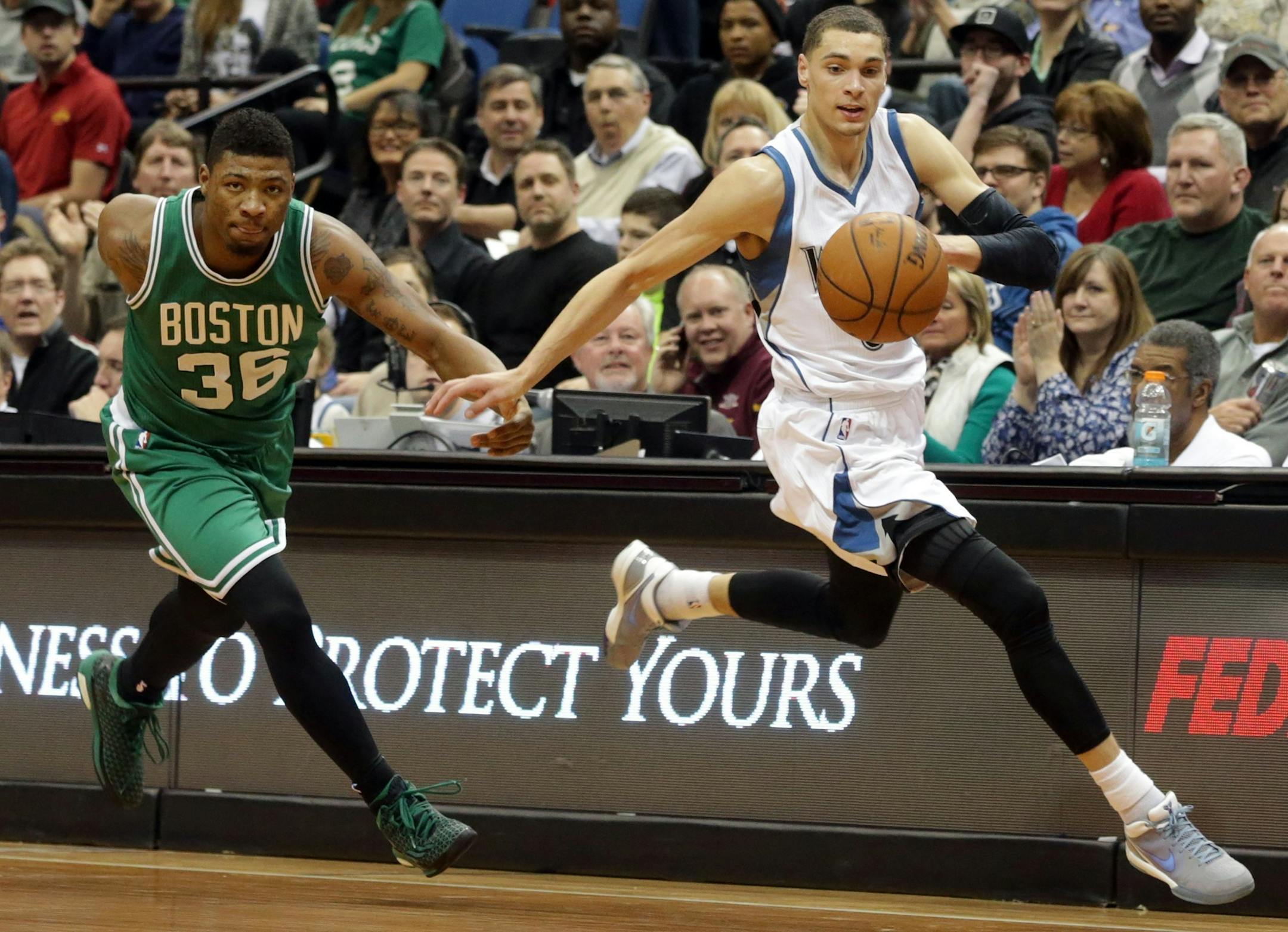 Minnesota Timberwolvesí Zach LaVine, right, drives the ball as he is pursued by Boston Celticsí Marcus Smart in the second half of an NBA basketball game, Wednesday, Jan. 28, 2015, in Minneapolis. The Timberwolves won 110-98. (AP Photo/Jim Mone)